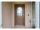 A close-up of a front door with an oval window, showcasing the entry of the home at 5433 81St Avenue E Cir, Palmetto, FL 34221