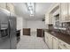 Bright modern kitchen with white cabinetry, stainless steel appliances and a breakfast bar at 5433 81St Avenue E Cir, Palmetto, FL 34221