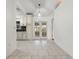 Bright kitchen featuring white cabinets, tiled floors, and double glass doors leading to outdoor space at 5433 81St Avenue E Cir, Palmetto, FL 34221