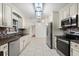 View of a recently remodeled modern kitchen with white cabinetry and stainless steel appliances at 5433 81St Avenue E Cir, Palmetto, FL 34221