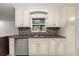 Updated kitchen features a stainless steel dishwasher and sink with a decorative backsplash at 5433 81St Avenue E Cir, Palmetto, FL 34221