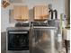 Laundry room featuring washer, dryer, utility sink, hot water tank, and cabinets at 5433 81St Avenue E Cir, Palmetto, FL 34221