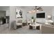 Bright living room with modern decor, neutral tones, ceiling fan, and tile flooring at 5433 81St Avenue E Cir, Palmetto, FL 34221