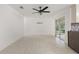 Bright living room featuring tile flooring, ceiling fan, and sliding glass doors to the backyard at 5433 81St Avenue E Cir, Palmetto, FL 34221