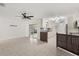 Bright living room and kitchen with tile flooring and sliding glass doors leading to the outside patio at 5433 81St Avenue E Cir, Palmetto, FL 34221