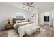Staged main bedroom with a ceiling fan, neutral decor, and ensuite bathroom at 5433 81St Avenue E Cir, Palmetto, FL 34221