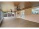 Enclosed patio features ceiling fans, textured flooring and access to the backyard at 5433 81St Avenue E Cir, Palmetto, FL 34221