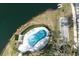 Aerial view of an outdoor pool with lounge chairs near the lake and lawn at 5433 81St Avenue E Cir, Palmetto, FL 34221