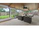 Screened porch featuring outdoor furniture and views of the backyard through large windows and ceiling fans at 5433 81St Avenue E Cir, Palmetto, FL 34221