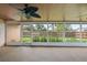 Screened porch featuring views of the backyard through large windows and ceiling fans at 5433 81St Avenue E Cir, Palmetto, FL 34221