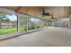 Spacious screened porch featuring views of the backyard through large windows and ceiling fans at 5433 81St Avenue E Cir, Palmetto, FL 34221