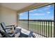 Relaxing balcony with seating overlooking serene golf course and water views at 5695 Palmer Cir # 203, Bradenton, FL 34211