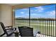 Cozy outdoor balcony featuring seating with stunning views of the golf course and lake at 5695 Palmer Cir # 203, Bradenton, FL 34211