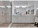 Double vanity bathroom with frameless glass shower and a plush floor covering at 5695 Palmer Cir # 203, Bradenton, FL 34211