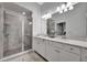 Elegant bathroom with double vanity, frameless glass shower and modern fixtures at 5695 Palmer Cir # 203, Bradenton, FL 34211