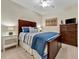 Comfortable bedroom with wooden accents, side table, and lots of natural light at 5695 Palmer Cir # 203, Bradenton, FL 34211