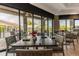 Inviting dining area with large windows offering views of the lush outdoor landscape and tables at 5695 Palmer Cir # 203, Bradenton, FL 34211