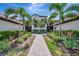 Beautiful condo complex featuring lush landscaping and a welcoming walkway to the units at 5695 Palmer Cir # 203, Bradenton, FL 34211