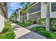 Attractive condo exterior with lush tropical landscaping, and inviting pathway at 5695 Palmer Cir # 203, Bradenton, FL 34211