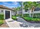 Charming condo exterior showcases tropical landscaping and a private entrance at 5695 Palmer Cir # 203, Bradenton, FL 34211