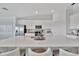 Bright, modern kitchen featuring a quartz countertop island and stainless steel appliances at 5695 Palmer Cir # 203, Bradenton, FL 34211