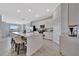 Open-concept kitchen featuring a large island with seating, white cabinets, and tile flooring at 5695 Palmer Cir # 203, Bradenton, FL 34211