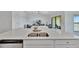 Modern kitchen island with a stainless steel sink and open view to the living room at 5695 Palmer Cir # 203, Bradenton, FL 34211