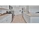 Lovely kitchen with stainless steel appliances, white cabinetry, and quartz counters at 5695 Palmer Cir # 203, Bradenton, FL 34211