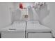 Efficient laundry room with washer, dryer, and shelving for storage at 5695 Palmer Cir # 203, Bradenton, FL 34211