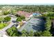 Aerial view of community amenities including pool, tennis court, and clubhouse surrounded by lush landscaping at 5866 Cavano Dr, Sarasota, FL 34231