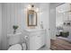 Compact powder room features a white vanity and bright lighting at 5866 Cavano Dr, Sarasota, FL 34231