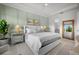 Cozy bedroom featuring a large white bed and an ensuite bathroom with a full mirror at 5866 Cavano Dr, Sarasota, FL 34231