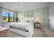 Bright bedroom with a white bed, light green walls, and a view to the outside at 5866 Cavano Dr, Sarasota, FL 34231
