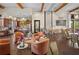 Open concept common room with lounge chairs, tables, kitchen, and a decorated interior at 5866 Cavano Dr, Sarasota, FL 34231
