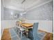 Dining room with elegant wainscoting, light fixture, and wood table that seats six at 5866 Cavano Dr, Sarasota, FL 34231