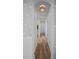 Inviting hallway featuring hardwood floors and stylish lighting fixtures at 5866 Cavano Dr, Sarasota, FL 34231