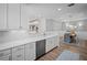 Open-concept kitchen with white cabinetry, stainless steel appliances, and views into the dining area at 5866 Cavano Dr, Sarasota, FL 34231