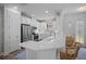 Bright kitchen featuring white cabinets, stainless steel appliances, and a breakfast bar with seating at 5866 Cavano Dr, Sarasota, FL 34231