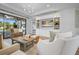 Bright living room with white built-ins, recessed lighting, and a sliding glass door to the patio at 5866 Cavano Dr, Sarasota, FL 34231