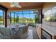 Enclosed patio with outdoor furniture, TV, ceiling fan, and views of the yard at 5866 Cavano Dr, Sarasota, FL 34231