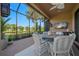 Enclosed patio with outdoor furniture, TV, ceiling fan, and views of the yard at 5866 Cavano Dr, Sarasota, FL 34231