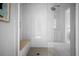Spa-like shower with a bench and sleek white tile and glass door at 5866 Cavano Dr, Sarasota, FL 34231