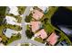 Aerial shot of a neighborhood with manicured lawns, tile roofs, and a tranquil pond at 5897 Carriage Dr, Sarasota, FL 34243