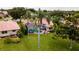 Aerial view of the property with a screened pool, mature trees and manicured lawn at 5897 Carriage Dr, Sarasota, FL 34243