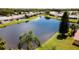 View of residential planned community around small lake with green space at 5897 Carriage Dr, Sarasota, FL 34243