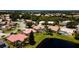Wide aerial of residential community with ponds, pools, lush landscaping and tiled roofs at 5897 Carriage Dr, Sarasota, FL 34243