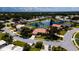 Aerial view of a beautiful home with a tile roof in a community near a lake at 5897 Carriage Dr, Sarasota, FL 34243