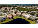 Picturesque aerial view of homes with backyard pools nestled around a serene pond at 5897 Carriage Dr, Sarasota, FL 34243