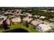 Aerial of neighborhood featuring tile roofs, swimming pools, landscaping, and water features at 5897 Carriage Dr, Sarasota, FL 34243