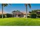 Landscaped backyard with screened pool area, plants, and palm trees at 5897 Carriage Dr, Sarasota, FL 34243